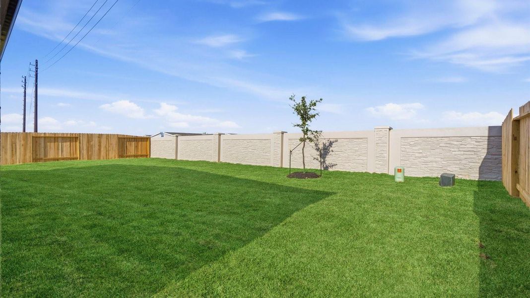 Large fenced-in backyard with a covered patio, perfect for outdoor entertaining.