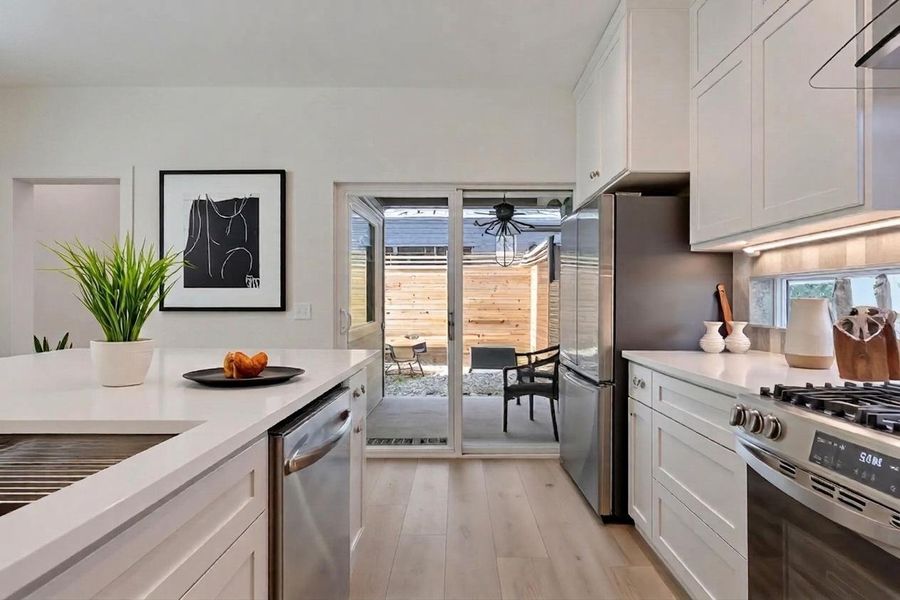 Sliding glass doors off the kithen lead to a covered patio. The dedicated office door is seen on the left. Sliding glass doors off the kithen lead to a covered patio. The dedicated office door is seen on the left.