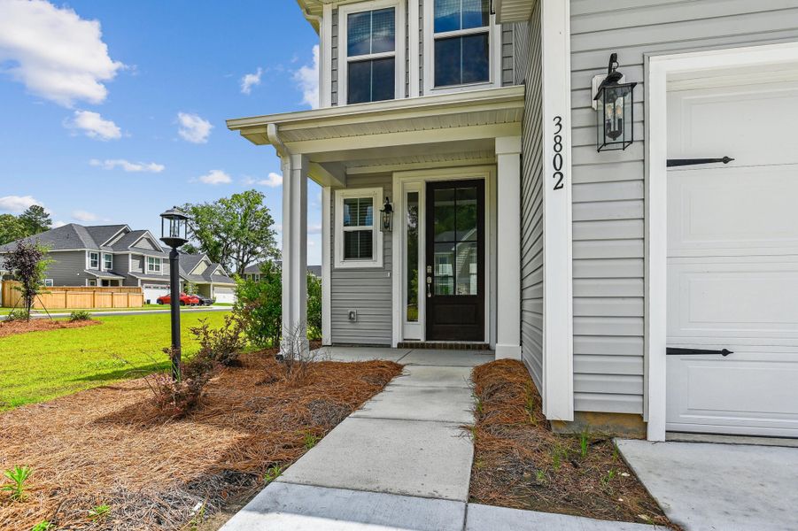 Front exterior of a new home in Windsor Crossing, North Charleston, SC, highlighting curb appeal (Image 2). Front exterior of a new home in Windsor Crossing, North Charleston, SC, highlighting curb appeal (Image 2).