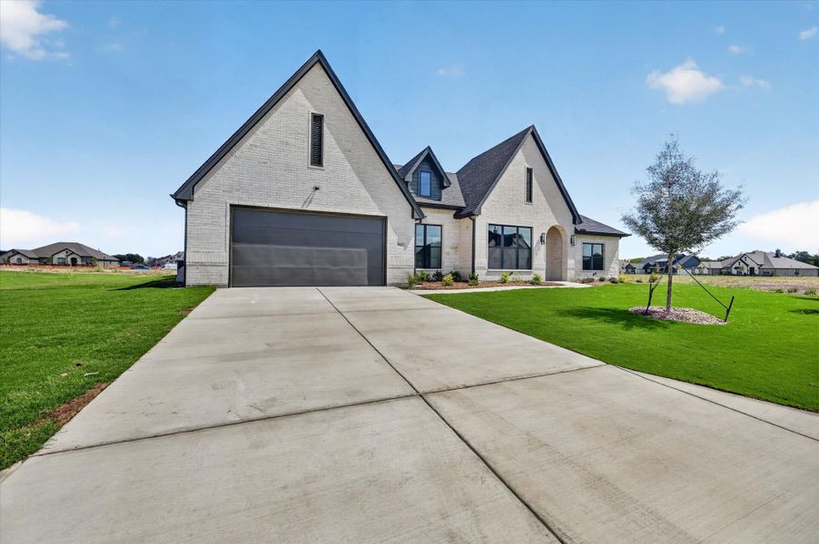 Front exterior of a new home in Paloma Ranches, Justin, TX, highlighting curb appeal (Image 22).