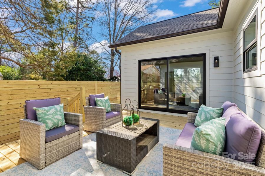 Private Courtyard Deck accessible by the Sunroom and Primary Bedroom