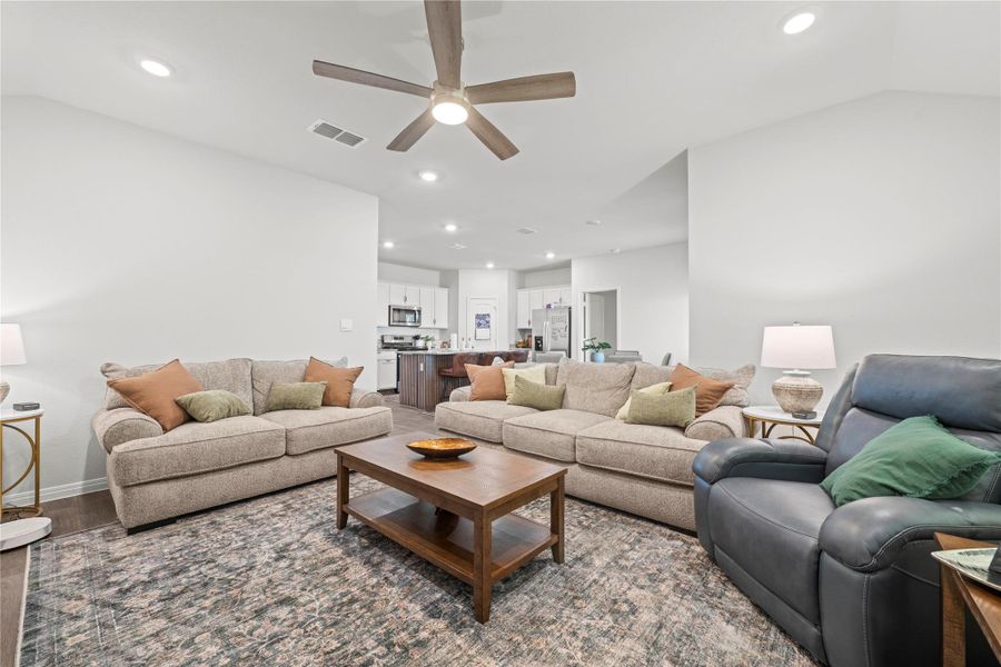 An open-concept living space integrates a well-appointed kitchen and comfortable seating, ideal for entertaining.