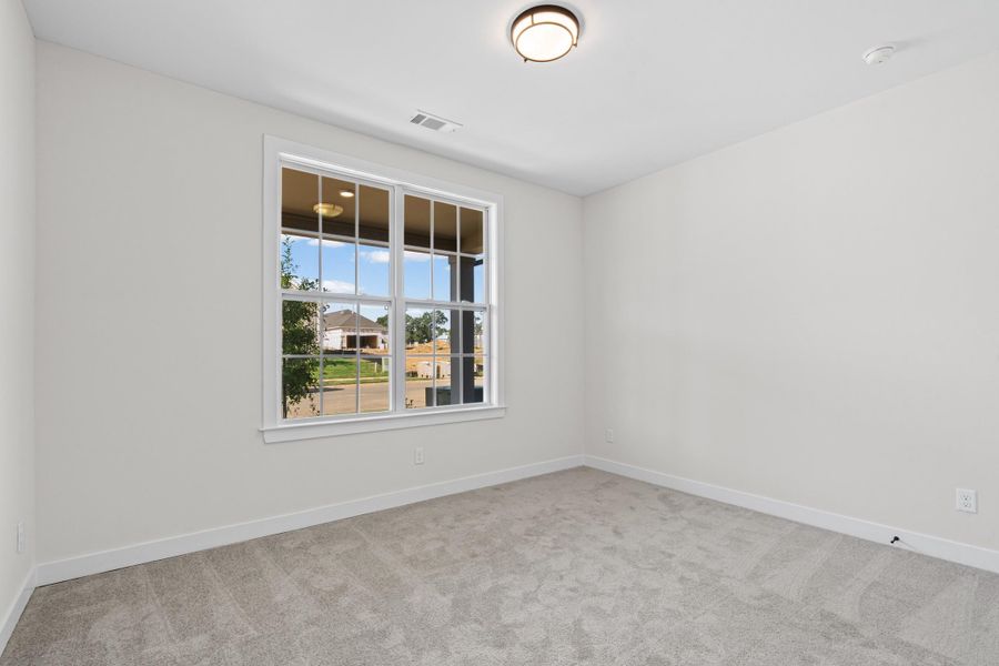 Neutral wall paint, plush carpet flooring, white trim, and a flush mount ceiling light Neutral wall paint, plush carpet flooring, white trim, and a flush mount ceiling light