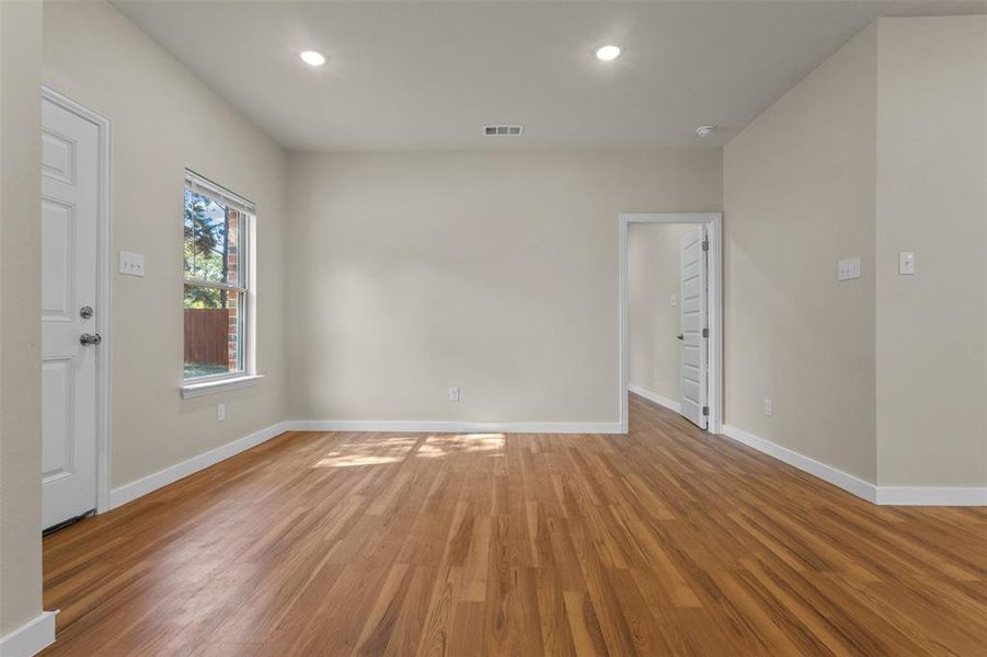 Empty room featuring light wood finished floors and recessed lighting Empty room featuring light wood finished floors and recessed lighting
