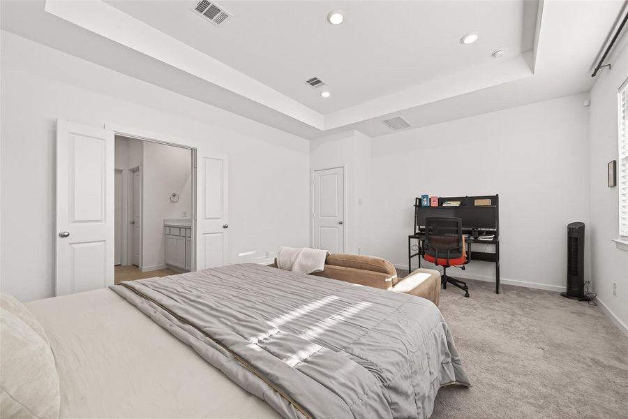The expansive primary suite offers generous space to accommodate a desk, sitting area, or additional dressers, allowing for easy customization to suit your lifestyle. Designed for comfort and versatility, this inviting retreat also provides direct access to a spacious walk-in closet and a private bathroom, creating a well-appointed and relaxing sanctuary.