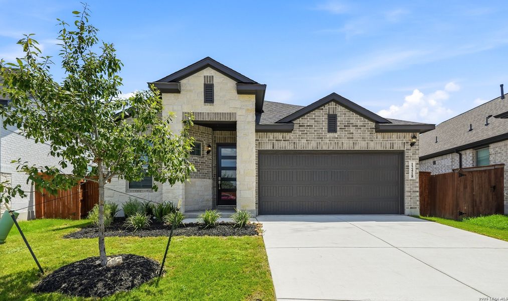 Front exterior of a new home in Stillwater Ranch, San Antonio, TX, highlighting curb appeal (Image 2). Front exterior of a new home in Stillwater Ranch, San Antonio, TX, highlighting curb appeal (Image 2).