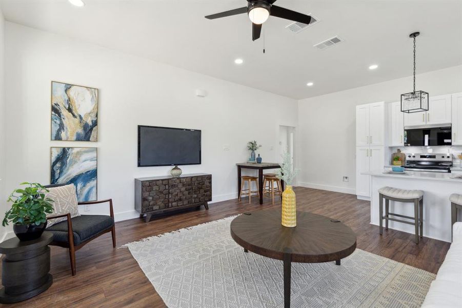 Living room is open to the kitchen and breakfast area. The door in the back is leads to the bedrooms Living room is open to the kitchen and breakfast area. The door in the back is leads to the bedrooms