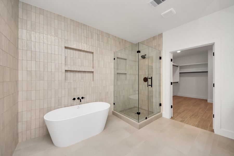 Freestanding Tub, floor to ceiling elegant tile wall