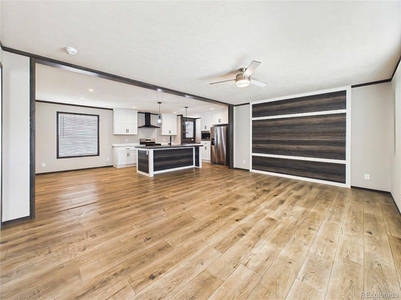 Open-Concept Living Area – Seamless flow between the living room, dining area, and kitchen, highlighted by wood beam accents and an airy layout ideal for everyday living.