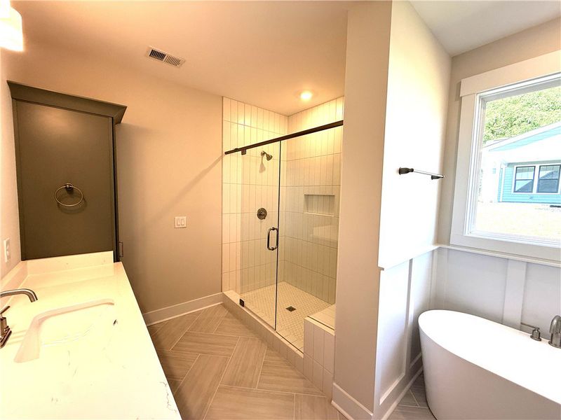 This spacious bathroom offers a serene retreat wit