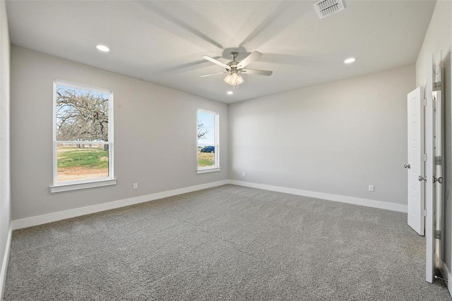 Empty room with light colored carpet, recessed lighting, and ceiling fan