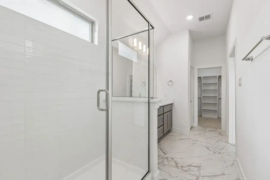 Primary Bathroom in the Claret home plan by Trophy Signature Homes – REPRESENTATIVE PHOTO