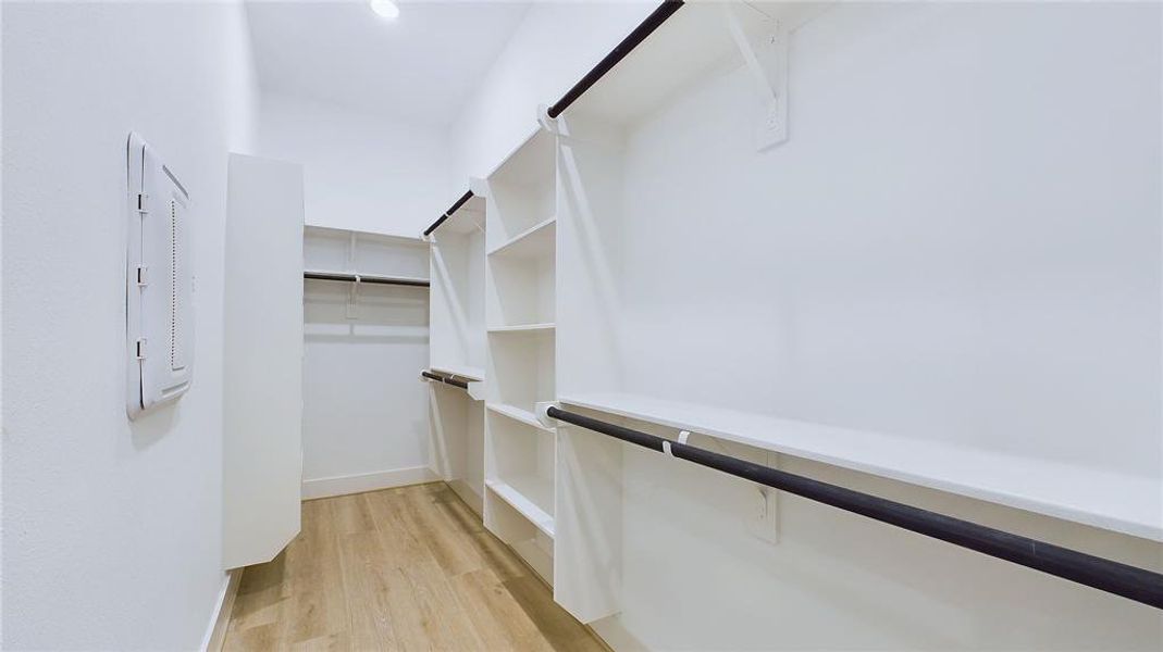 The closet provides ample double-hanging space, featuring two built-in shoe storage racks and additional long-hanging space for added convenience.