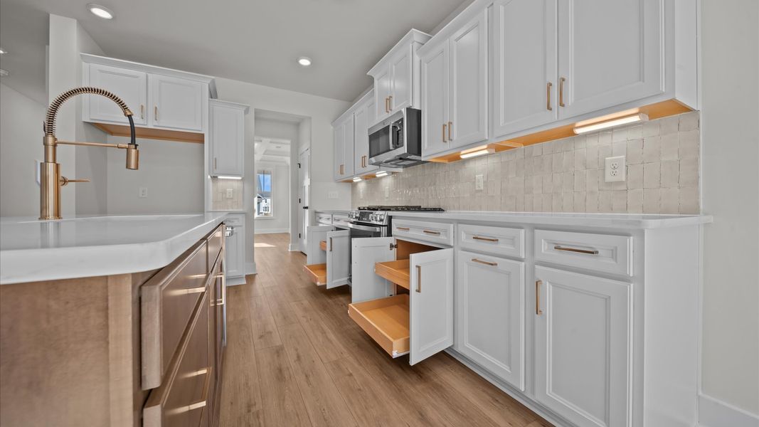 Superior craftsmanship shines in this modern kitchen with a space-saving island and open flow Superior craftsmanship shines in this modern kitchen with a space-saving island and open flow