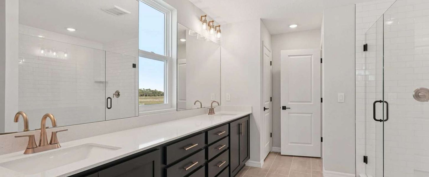 Spacious primary bathroom with a walk-in shower and enclosed water closet - representative image this home will feature AW Collection® Laguna Spacious primary bathroom with a walk-in shower and enclosed water closet - representative image this home will feature AW Collection® Laguna
