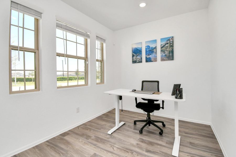 A perfect office in the the front of your home with natural light ideal for remote work or study with natural light streaming through the windows.