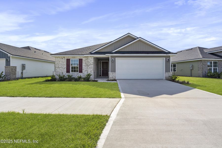 Front exterior of a new home in Summerglen, Jacksonville, FL, highlighting curb appeal (Image 18).