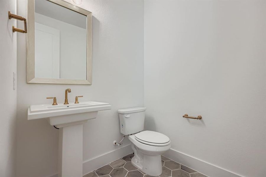 Bathroom featuring tile patterned flooring and baseboards Bathroom featuring tile patterned flooring and baseboards