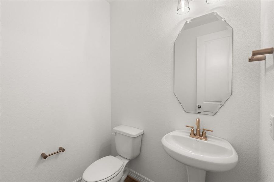 This charming home features a beautifully appointed half bath adjacent to the family room, perfect for welcoming guests and adding convenience to your daily life.