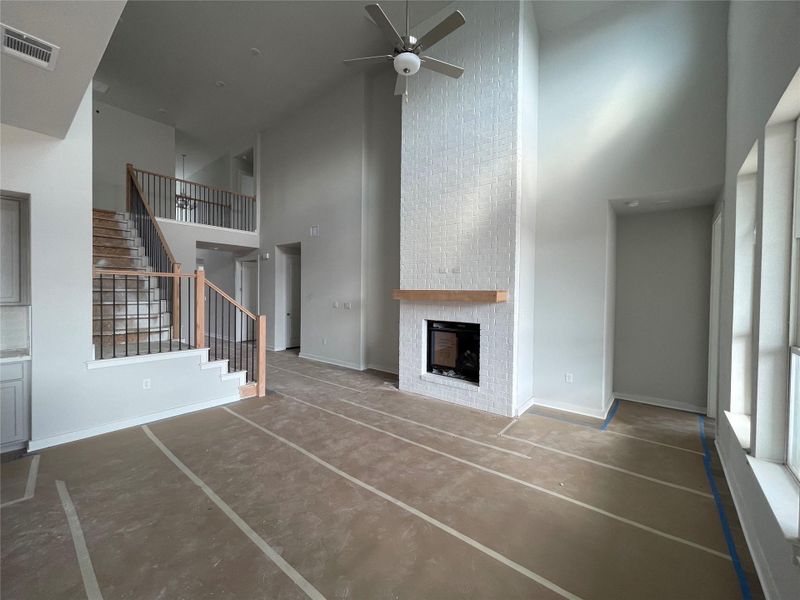 Family Room with soaring ceiling & fireplace