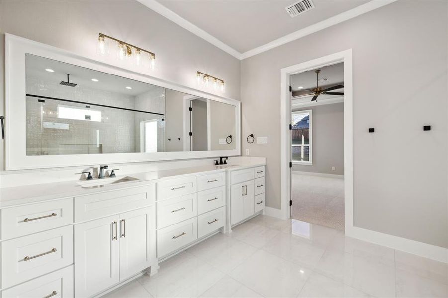 Bathroom with tile patterned flooring, ceiling fan, a shower with door, and vanity