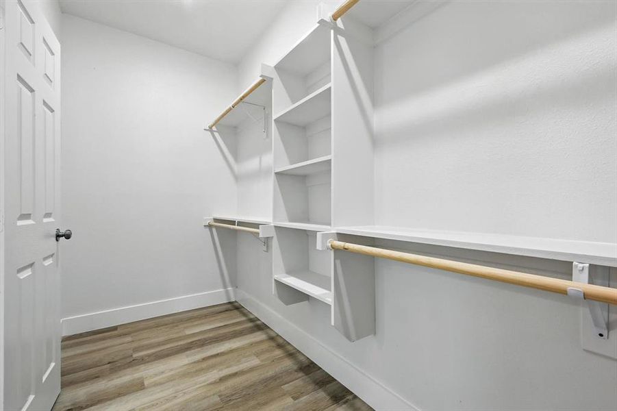 Walk in closet featuring light wood-type flooring Walk in closet featuring light wood-type flooring