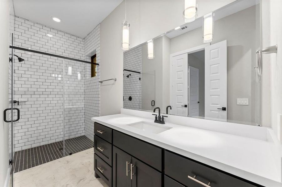 Elegant and spacious bathroom with ample storage, perfect for accommodating guests or older family members seeking convenient downstairs living.