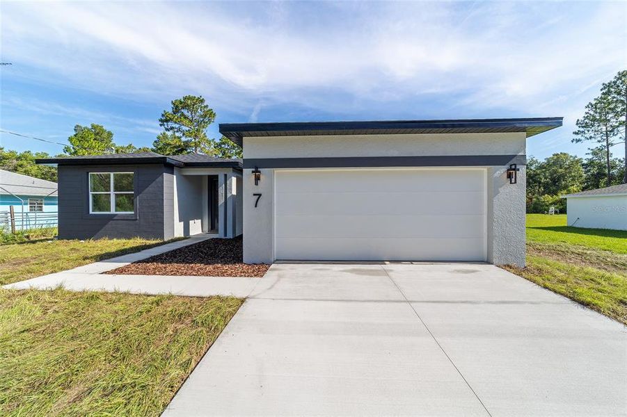 Front exterior of a new home in , Ocala, FL, highlighting curb appeal (Image 1).