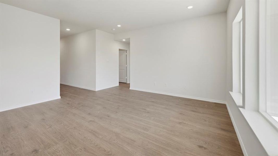 Empty room with recessed lighting and light wood-style floors