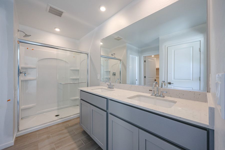 A bathroom with a glass shower. A bathroom with a glass shower.