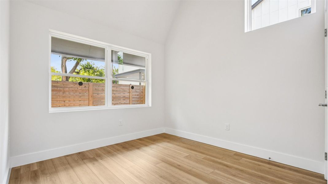 Spare room featuring wood finished floors and baseboards Spare room featuring wood finished floors and baseboards