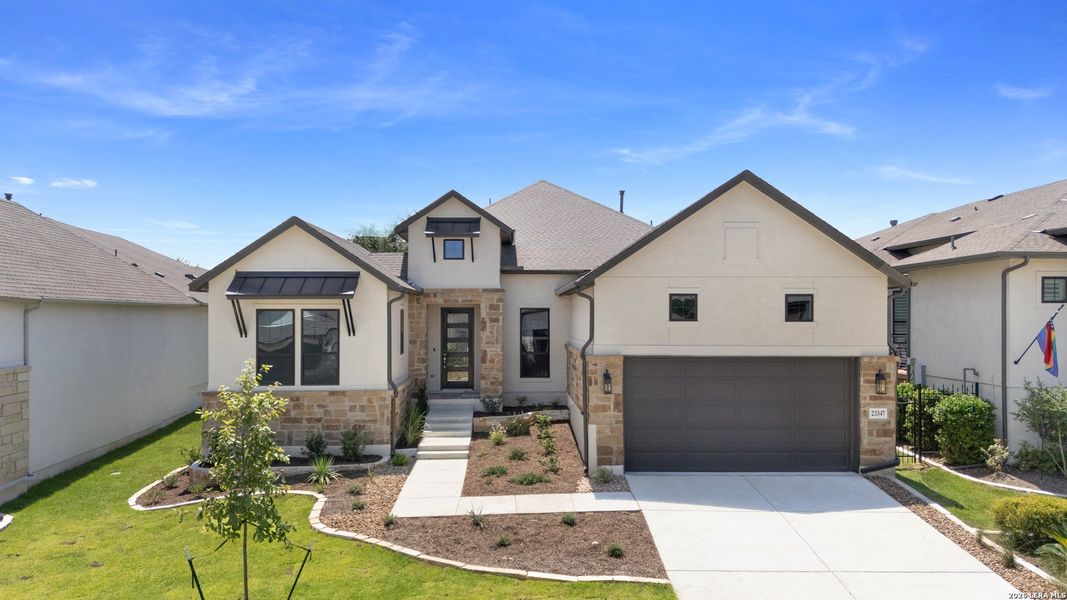 Front exterior of a new home in El Sonido at Campanas, San Antonio, TX, highlighting curb appeal (Image 20).