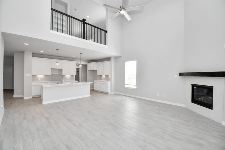 Welcome family and guests to your charming living room! With its high ceilings, recessed lighting, ceiling fan, custom paint, beautiful flooring, and large windows that let in abundant natural light, this room is perfect for gatherings. Welcome family and guests to your charming living room! With its high ceilings, recessed lighting, ceiling fan, custom paint, beautiful flooring, and large windows that let in abundant natural light, this room is perfect for gatherings.