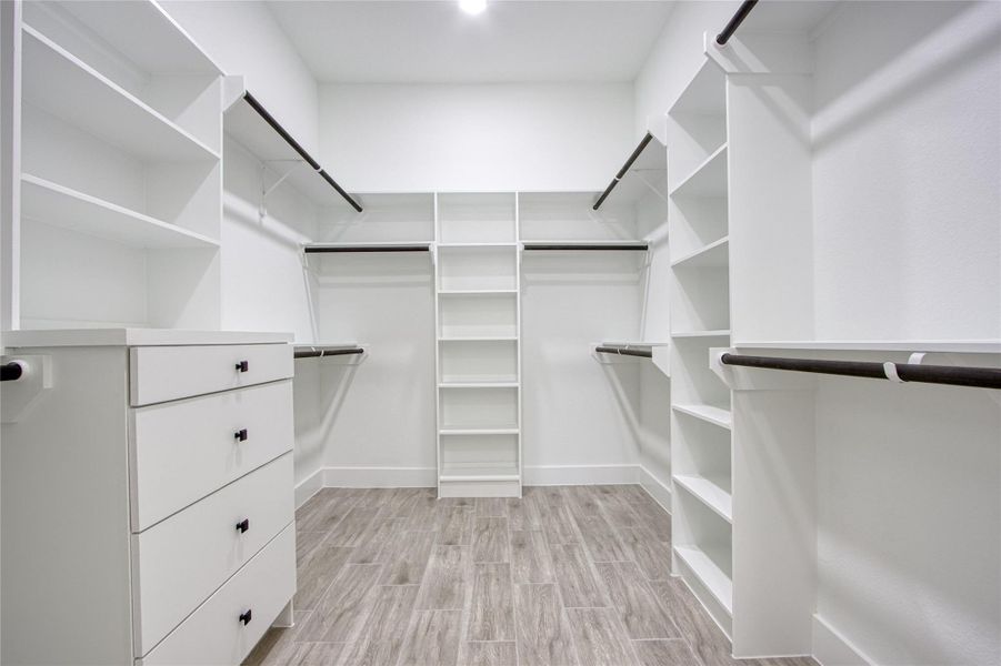 Large walk in primary closet with lots of built ins! Large walk in primary closet with lots of built ins!