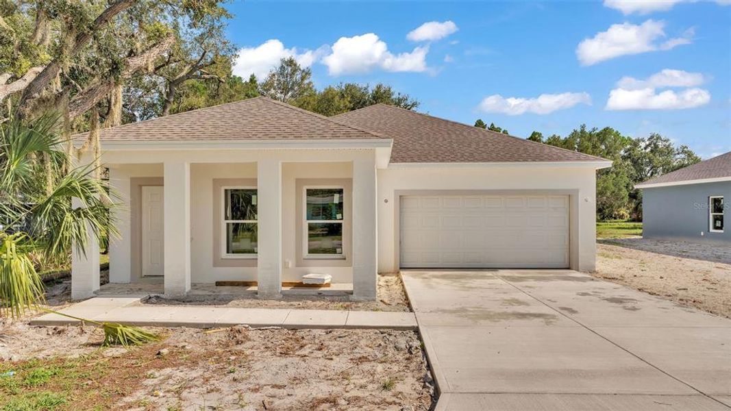 Front exterior of a new home in , Winter Haven, FL, highlighting curb appeal (Image 11).