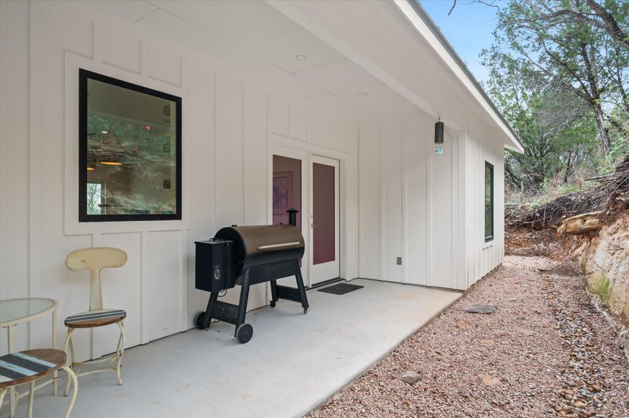 Covered back patio with complete privacy,  small back area features a river rock drain area, flag stone steps and local granite