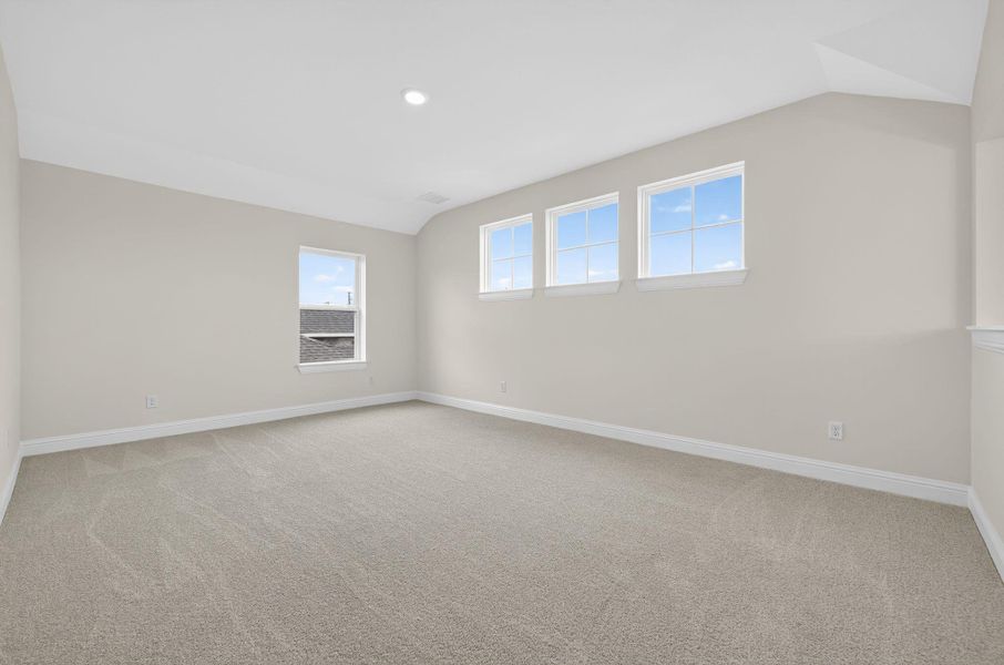 Spare room with light colored carpet, vaulted ceiling, and recessed lighting