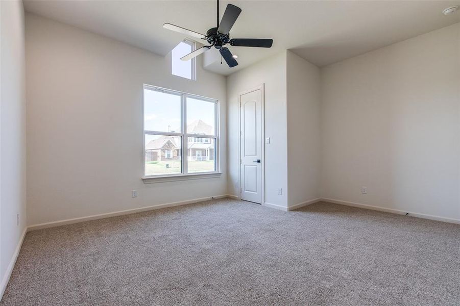 Carpeted empty room with ceiling fan