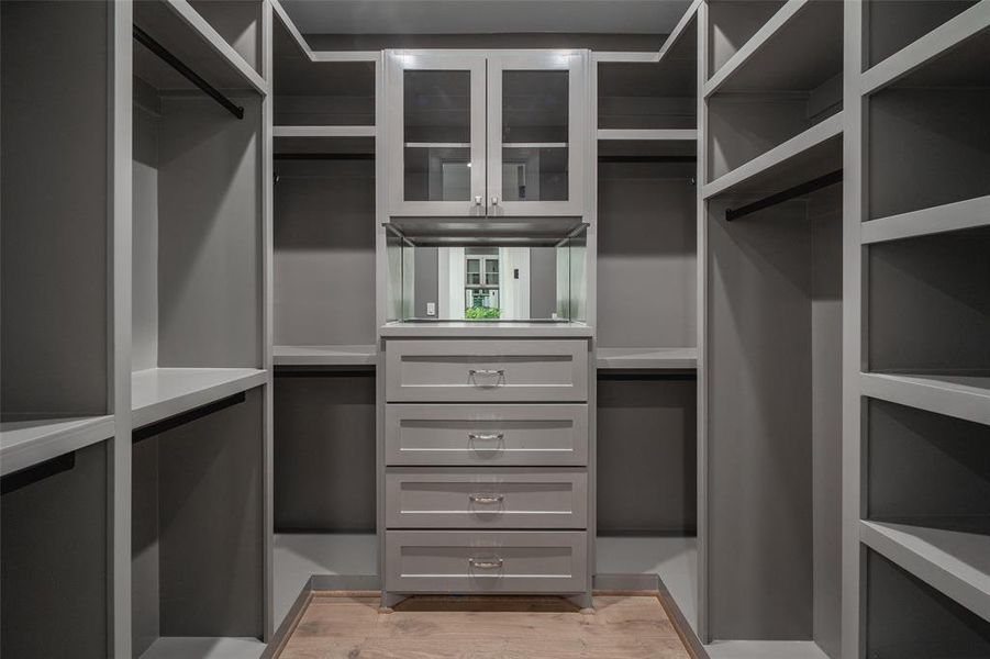 Spacious closet with light hardwood / wood-style floors