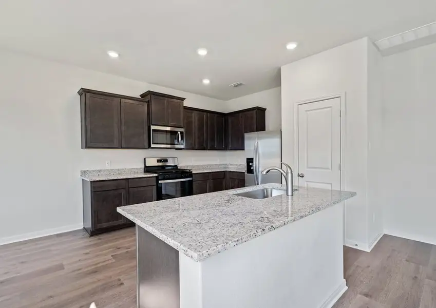 The kitchen has beautiful wood cabinetry.