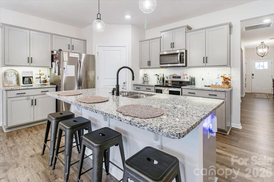 Open kitchen with island and stainless steel appliances Open kitchen with island and stainless steel appliances