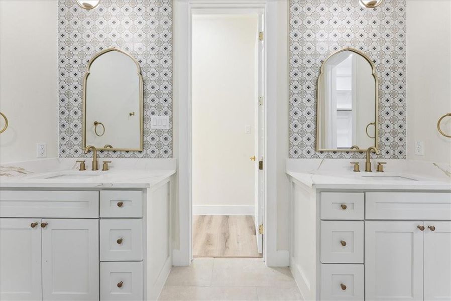 Bathroom featuring two vanities and light tile patterned flooring