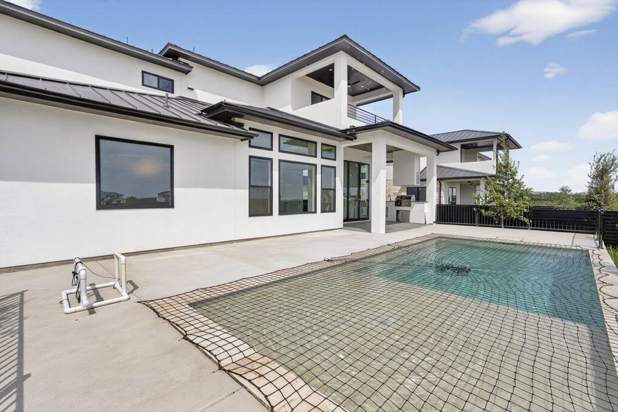 Exterior details and patio area of a home in Milky Way at River Place, Austin (Image 20).