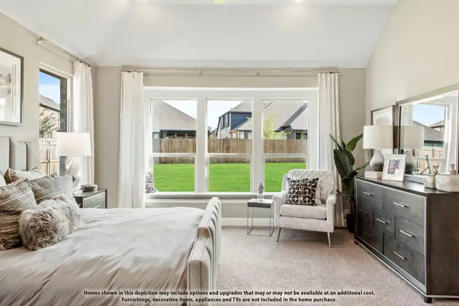 Bedroom with large bay window, vaulted ceiling, carpet flooring, and dark wood dresser