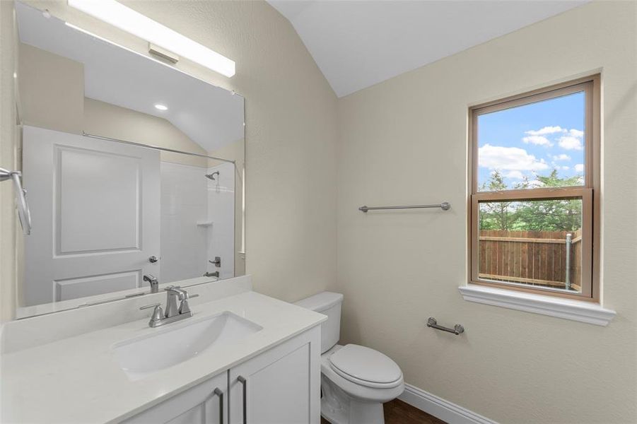 Contemporary bathroom featuring a single vanity with an integrated sink, white countertop, and brushed nickel faucet