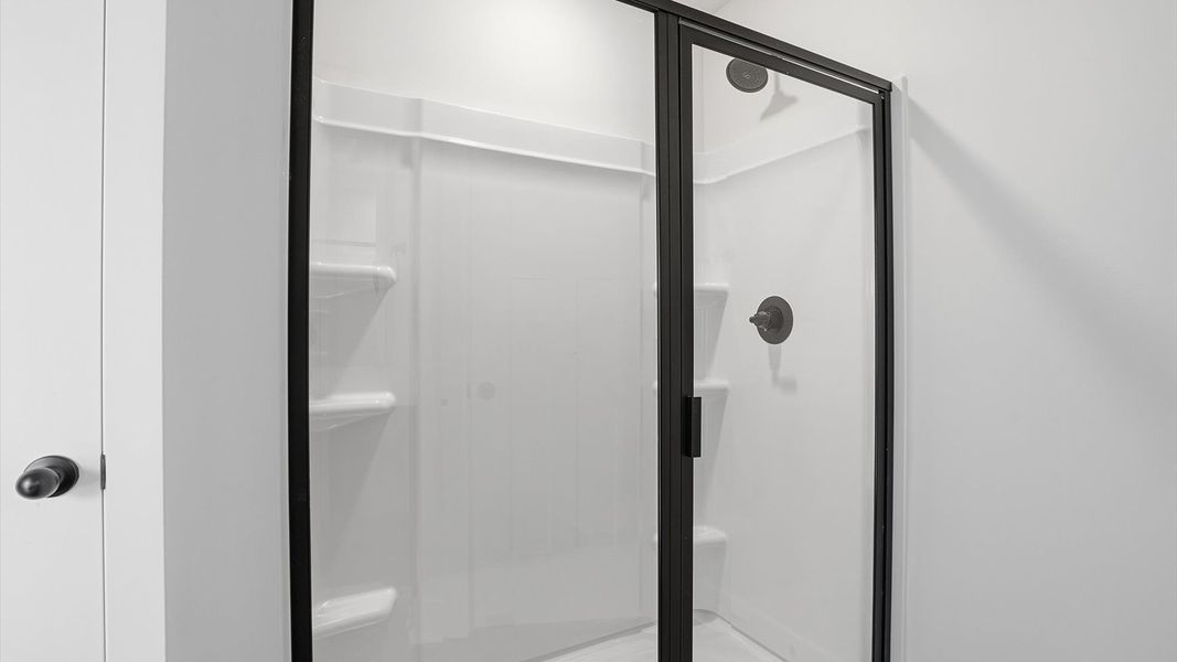 Elegant primary bathroom featuring a spacious walk-in shower in this first-class DRB Homes design Elegant primary bathroom featuring a spacious walk-in shower in this first-class DRB Homes design