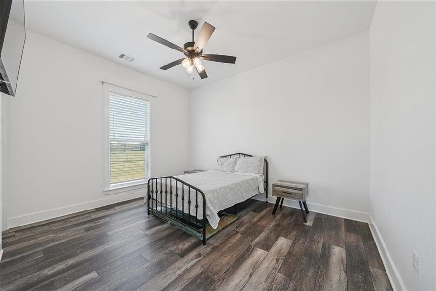 Bedroom featuring a ceiling fan and dark wood finished floors