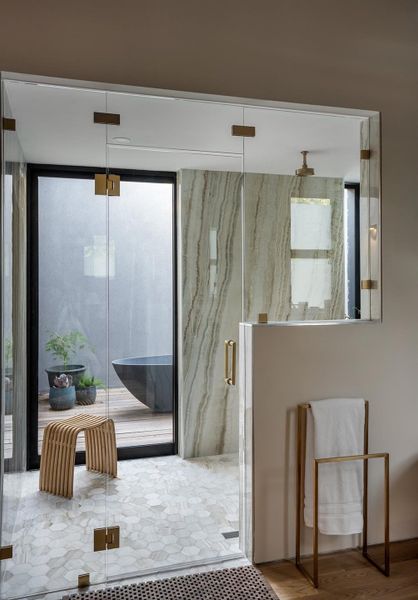 Walk in Shower to exterior patio with outdoor tub.
