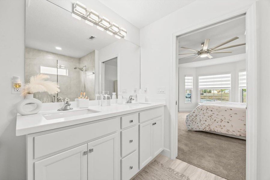 Master En-Suite with Double Sinks and Seamless White Corian Surfaces