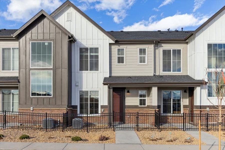 Front exterior of a new home in Pacific Collection at The Townes at Skyline Ridge, Castle Pines, CO, highlighting curb appeal (Image 35). Front exterior of a new home in Pacific Collection at The Townes at Skyline Ridge, Castle Pines, CO, highlighting curb appeal (Image 35).